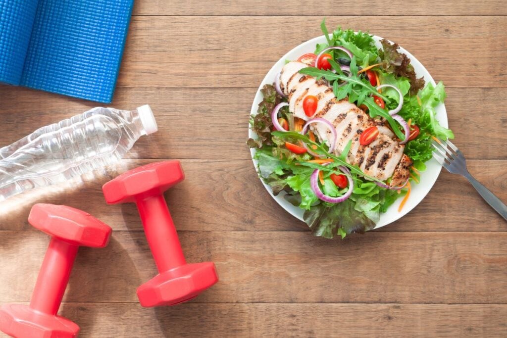 yoga mat, water, hand weights and plate of salad are examples of how to fall asleep at night naturally 